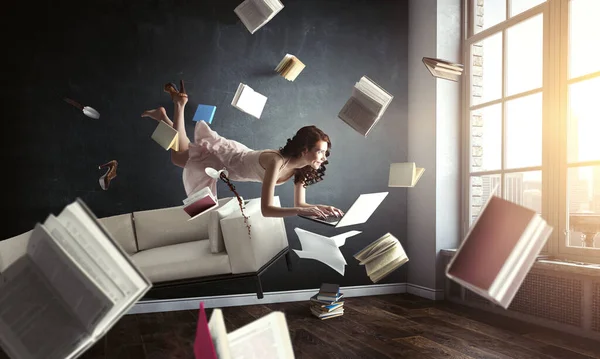 Jonge vrouw zweeft tijdens het lezen van een boek — Stockfoto