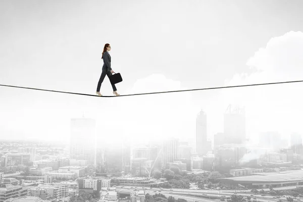 Image of businesswoman balancing on rope. Risk concept — Stock Photo, Image