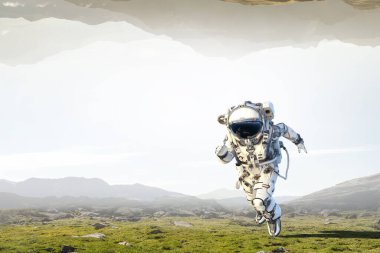 Keşfedilmemiş bir gezegende yürüyen astronot