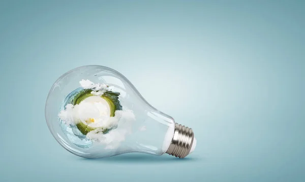 Green landscape inside light bulb — Stock Photo, Image