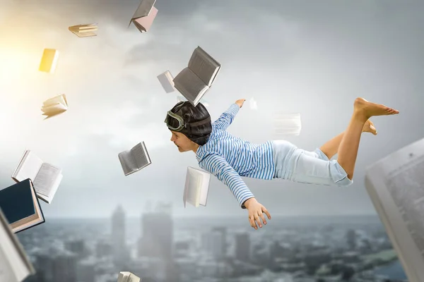World of books concept with flying boy — Stock Photo, Image