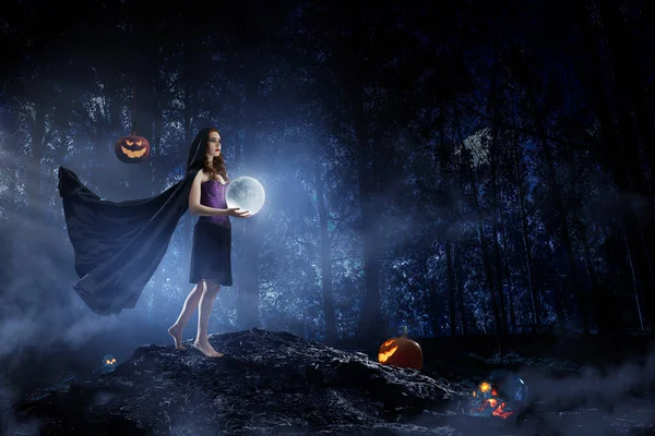 Beautiful young woman in witches hat and costume — Stock Photo, Image