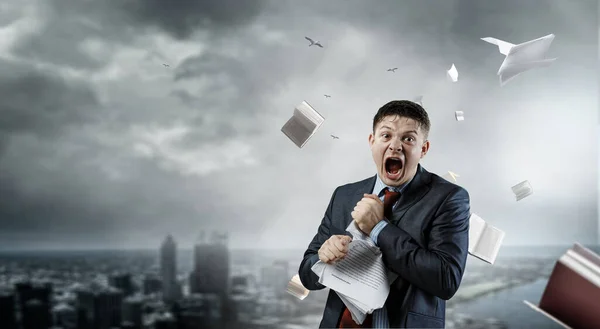 Young stressed man ripping documents with frustrated facial expression. — Stock Photo, Image