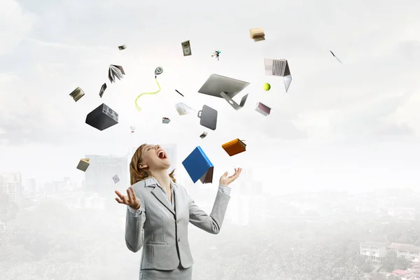 Young pretty businesswoman juggling with business items — Stock Photo, Image