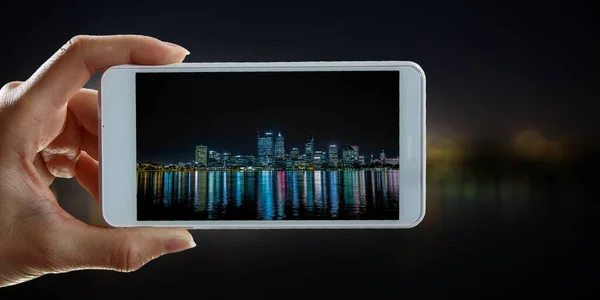 Mano celebración de teléfono inteligente móvil. Medios mixtos — Foto de Stock