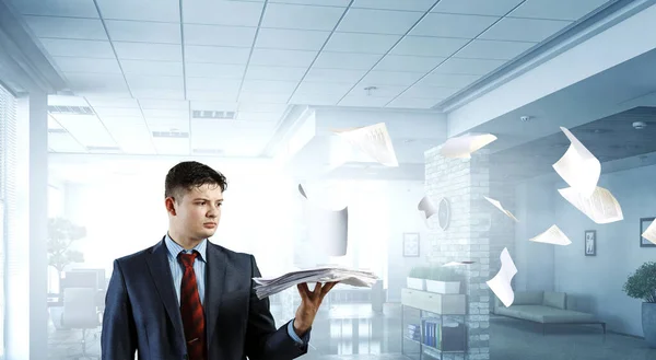 Business Concept - handsome young professional businessman holding report papers — Stock Photo, Image