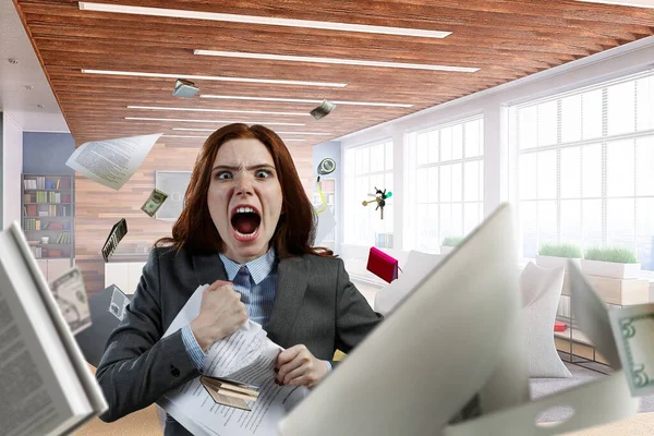 Young stressed woman ripping documents with frustrated facial expression.