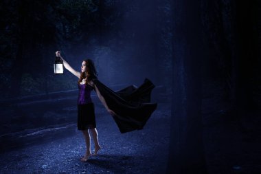 Cadı şapkası ve kostümü giymiş güzel bir kadın. Cadılar Bayramı sanat tasarımı. Karışık ortam