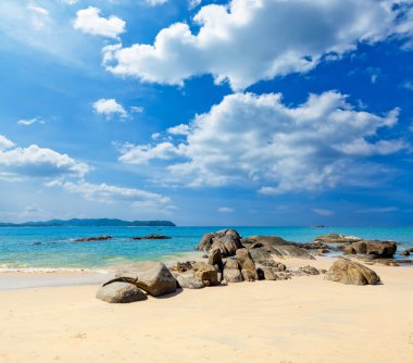 Landscape with white beach, the sea and the beautiful clouds in the blue sky