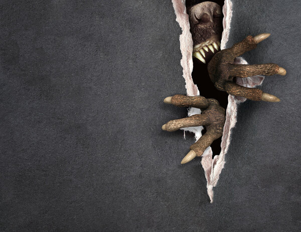 Monster tearing a paper