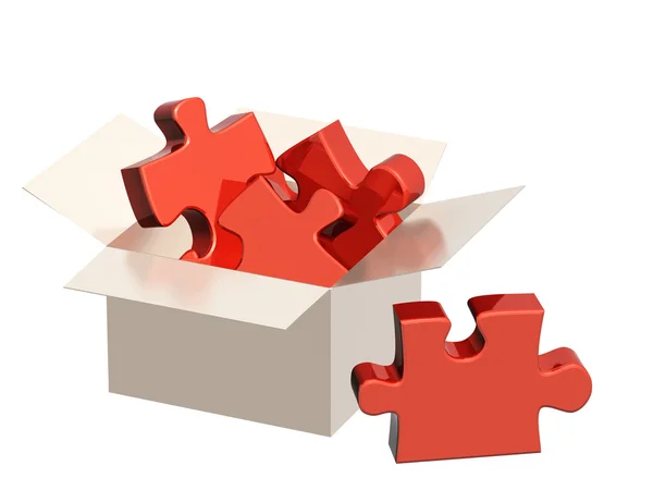 Delen van een puzzel in kartonnen doos — Stockfoto