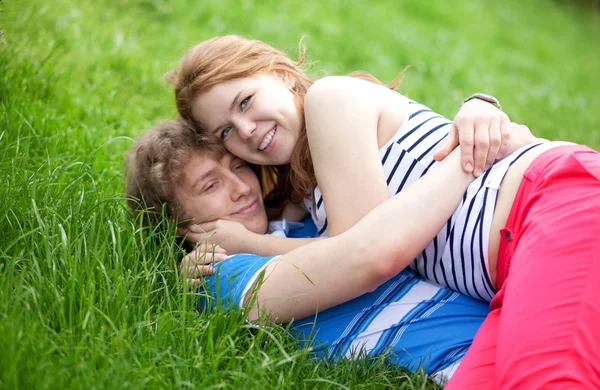 Young happy couple having fun together in park — Stock Photo, Image