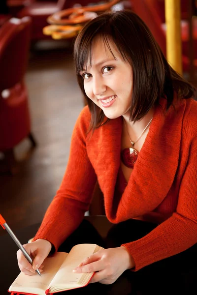 Beautiful girl with her personal organizer in a Parisian cafe — Stock Photo, Image