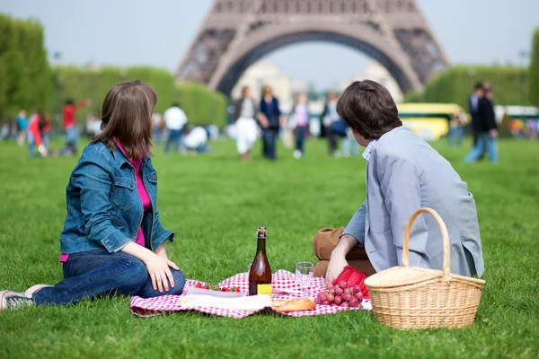 Jong koppel met een picknick in de buurt van de Eiffeltoren — Stockfoto