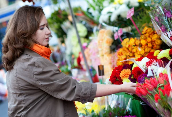 Beautiful woman buying flowers at market — Stock Photo, Image