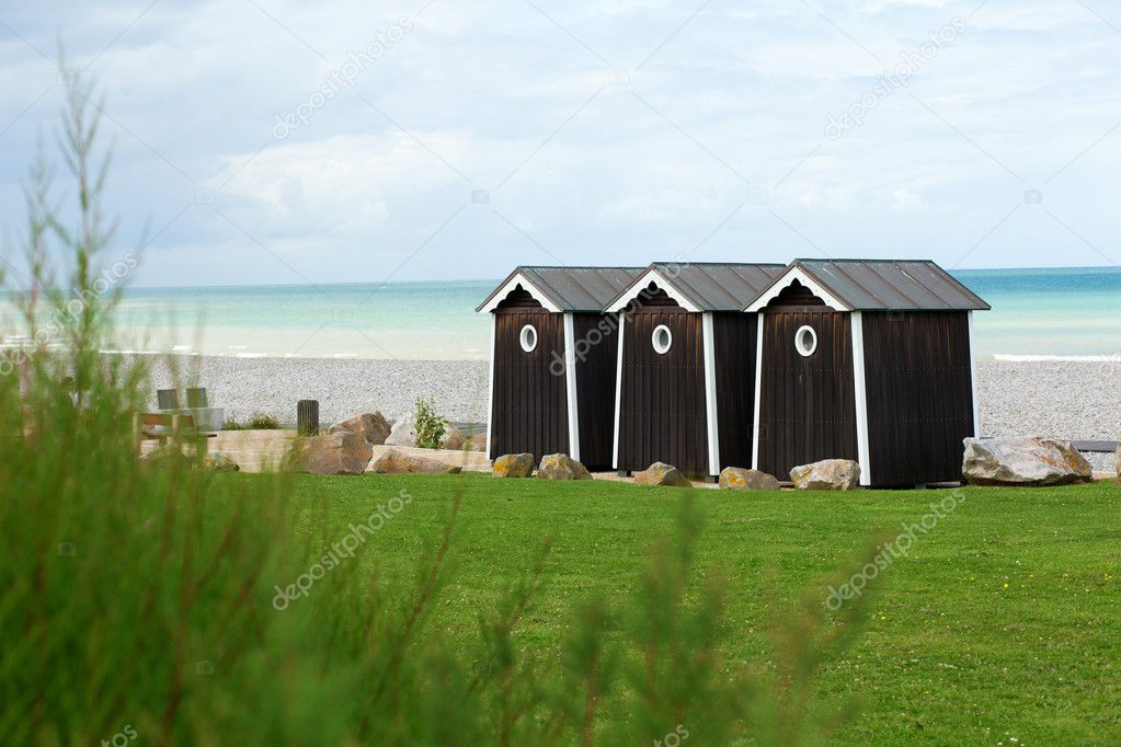 Three cabanas on a beach in Normandy, France