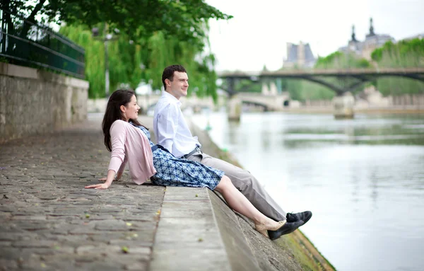 Joyful couple is sitting on the embankment — Stok fotoğraf