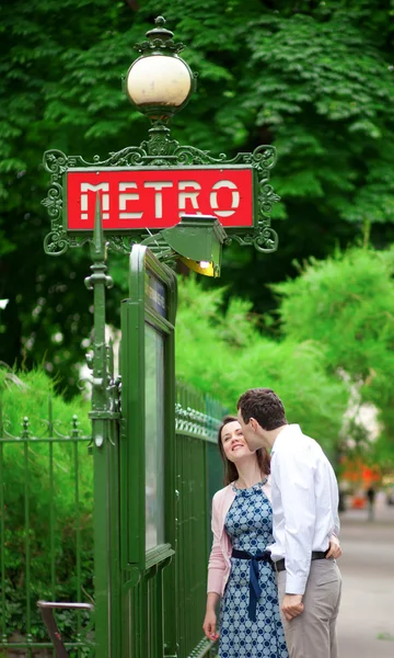 Beautiful couple is kissing near the metro station in Paris — Stock Photo, Image