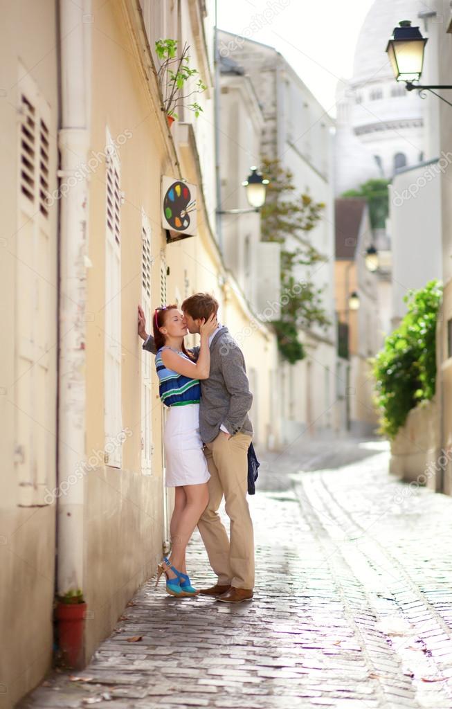 Romantic couple kissing on a street of Montmartre in Paris