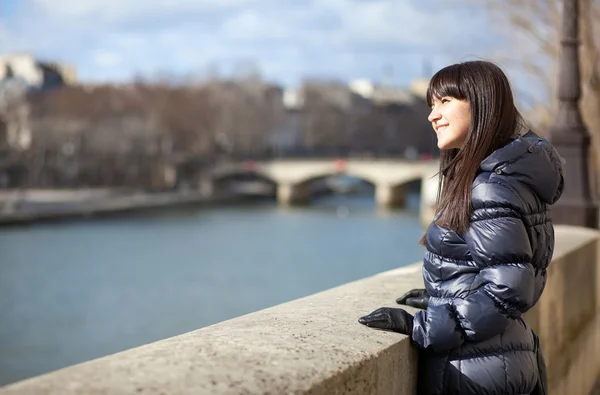 Happy brunette girl at Parisian embankment enjoying warm spring — Stock Photo, Image