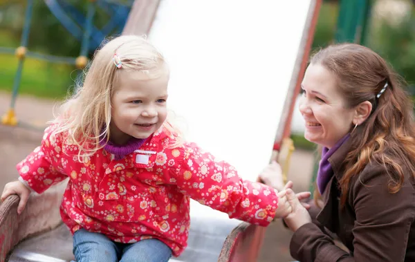 Mother and daughter together on playground — Stock Photo, Image