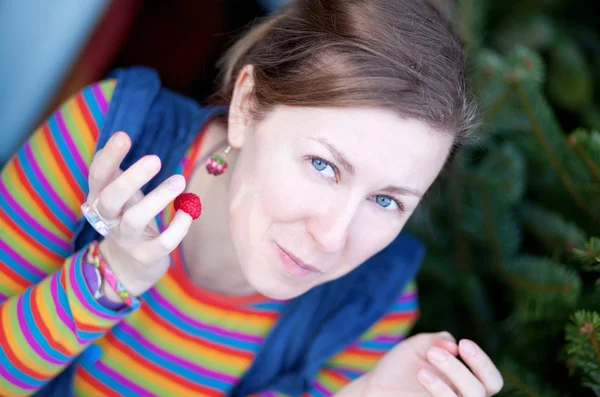 Beautiful young girl in bright clothes with raspberry — Stock Photo, Image