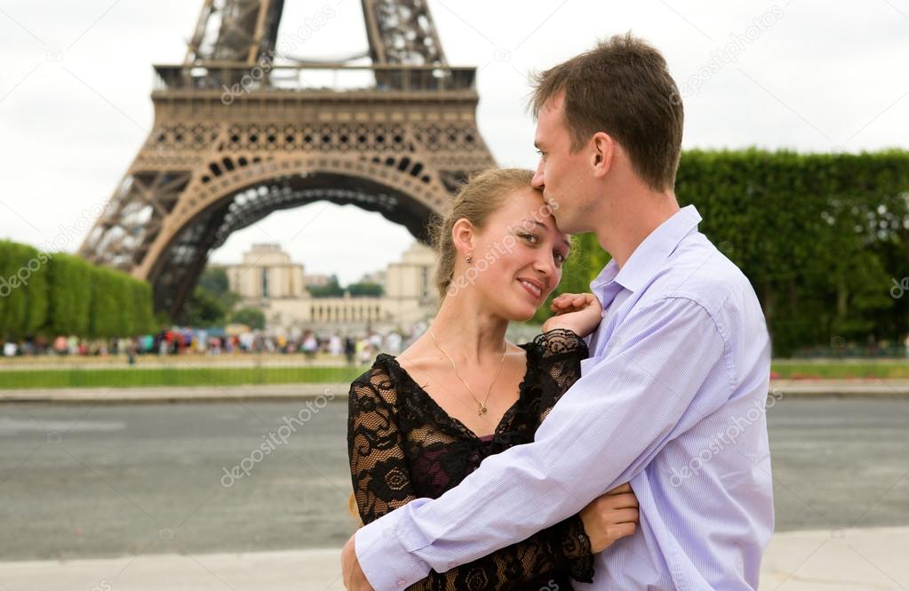 Happy couple in love in Paris near the Eiffel Tower