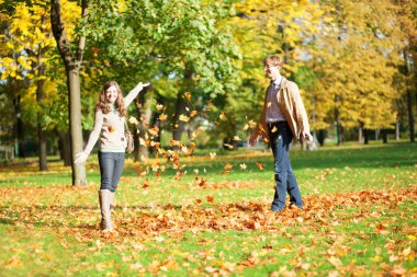 sonbahar yaprakları ile oynayan Çift