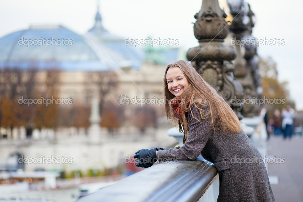 Happy positive girl on the Pont Alexandre III in Paris