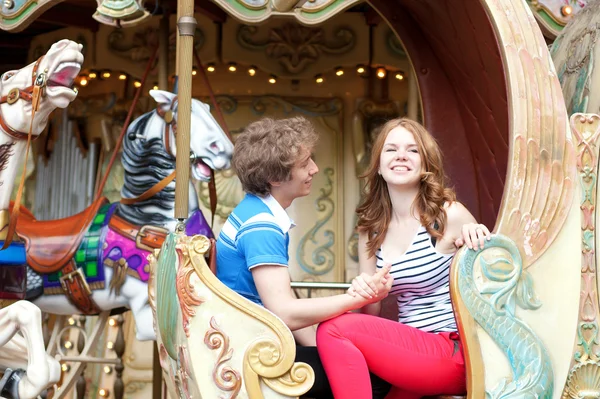 Happy young couple in an equipage of vintage Parisian merry-go-r — Stock Photo, Image