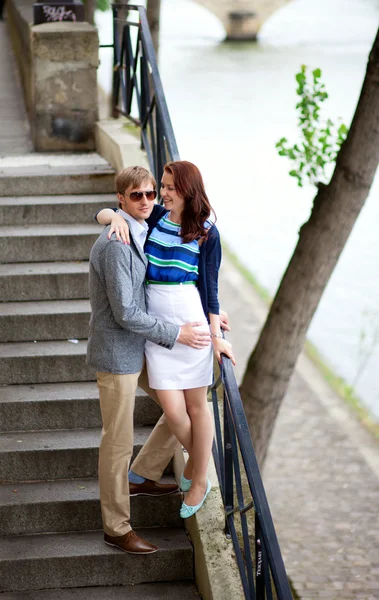 Romantic couple on the stairs at the Seine embankment — Stock Photo, Image