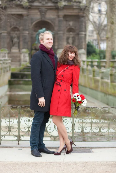 Dating couple with beautiful bunch of anemones — Stock Photo, Image