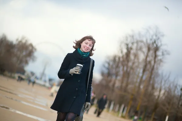 Young girl with taken away coffee in park — Stock Photo, Image