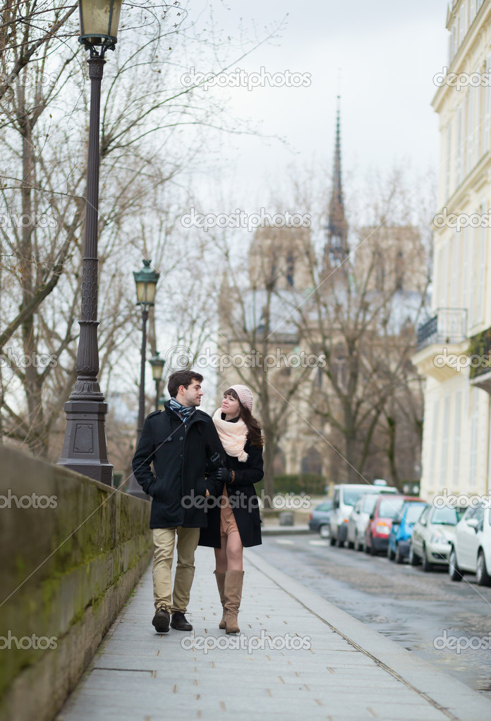 Young romantic couple walking in Paris
