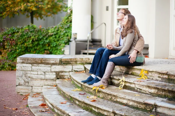Dating couple sitting on the stairs — Stock Photo, Image