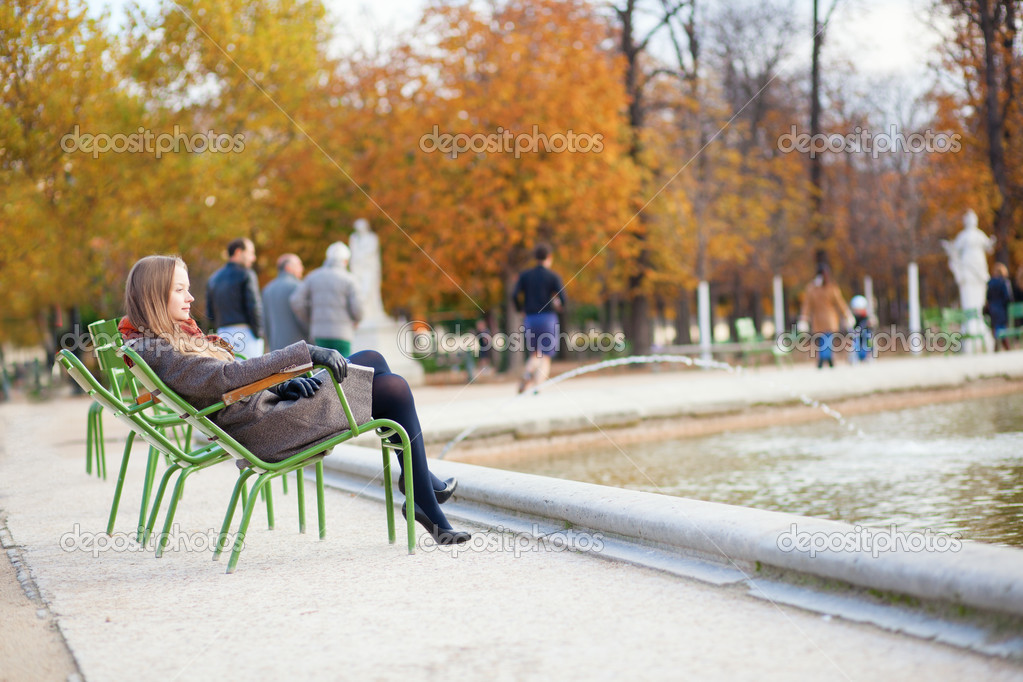 Girl enjoying beautiful autumn day in a park