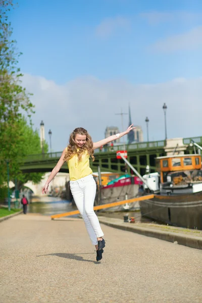 Happy girl jumping on the embankment — Stock Photo, Image