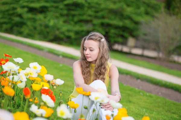 Girl with beautiful orange and yellow poppies — Stock Photo, Image