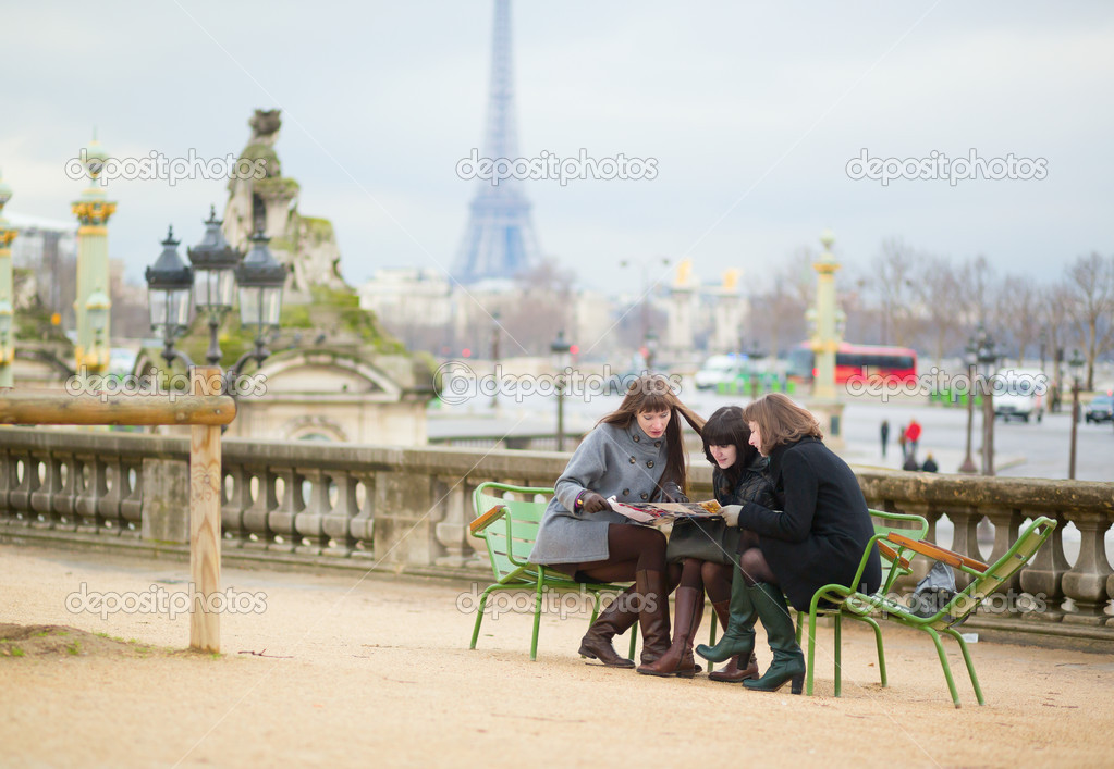 Tourists in Paris planning their trip using map