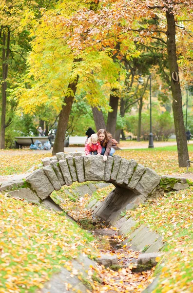 Mother and daughter on a beautiful bridge — Stock Photo, Image