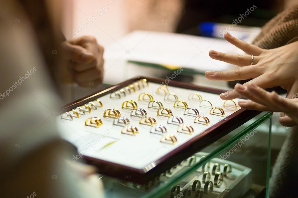 Woman trying wedding rings at a jeweller