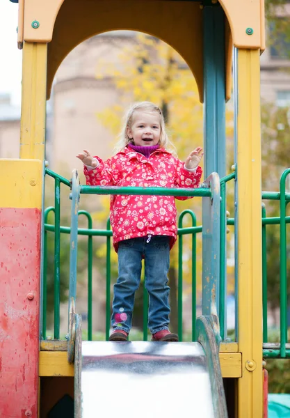 Adorable little girl having fun on the playground — Stock Photo, Image