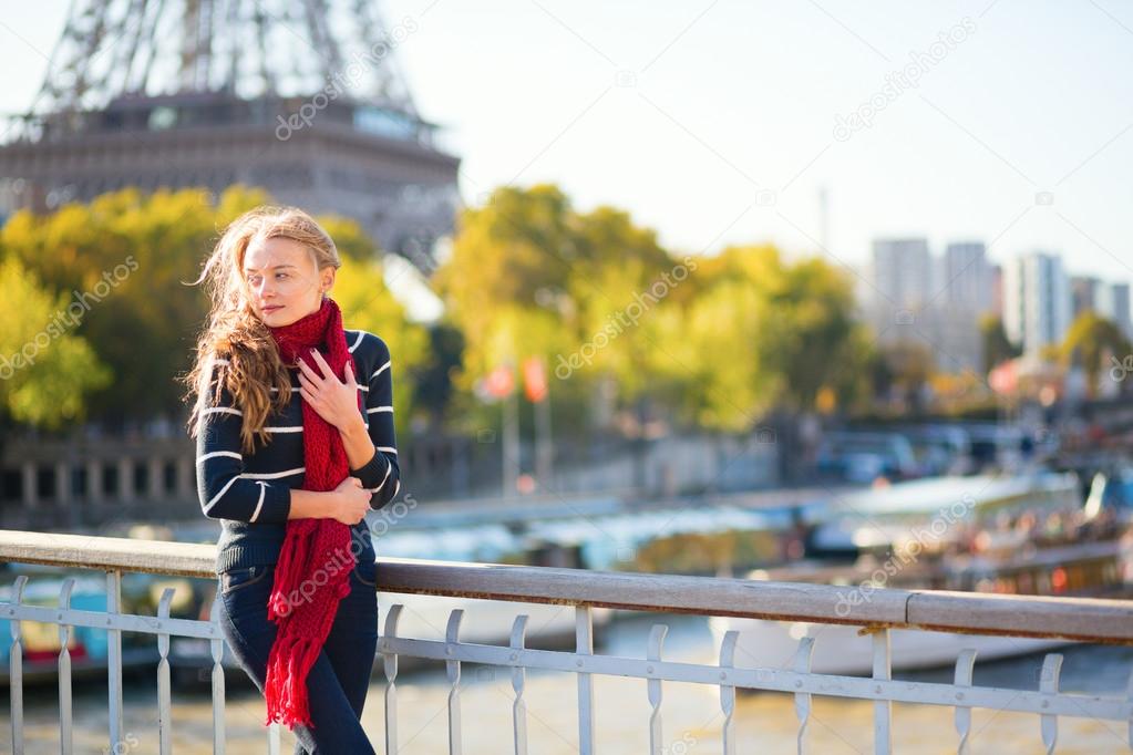 Young girl in red scarf on a fall day in Paris