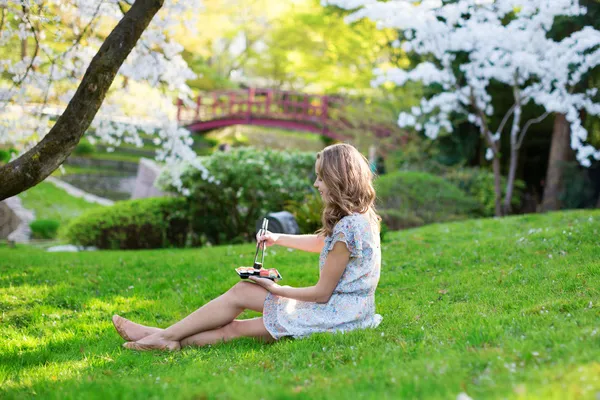 Young woman eating sushi in Japanese park — Stock Photo, Image