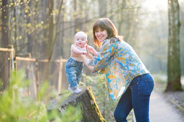 Young mother with her son in a spring forest — Stock Photo, Image