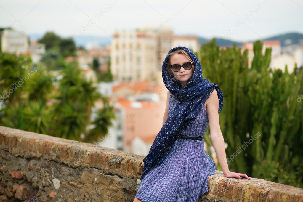Elegant young woman in the Old town of Cannes