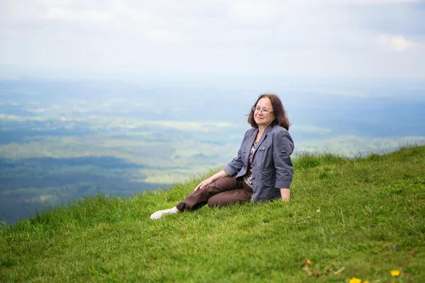 Middle aged woman on the slope of volcano — Stock Photo, Image