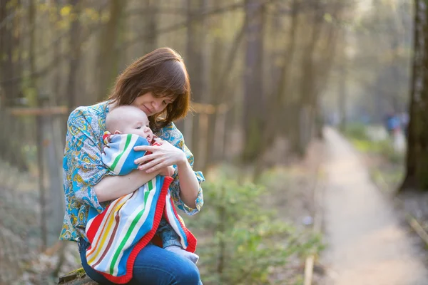 Young mother with her little baby in forest — Stock Photo, Image
