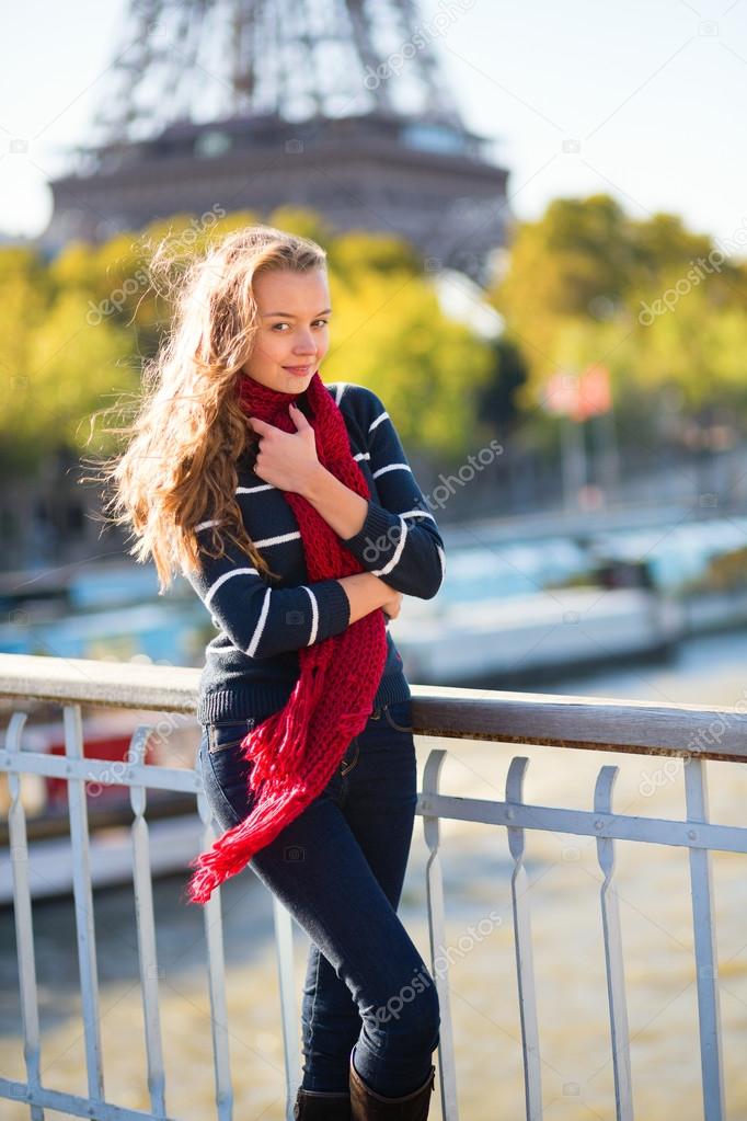 Young girl in red scarf on a fall day in Paris