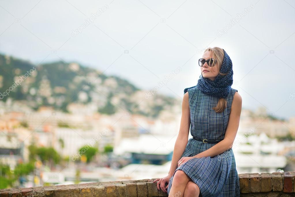 Elegant young woman in the Old town of Cannes